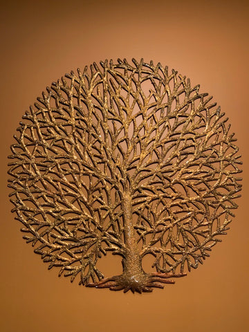 round gold tree of life made in haiti from recycled oil drums
